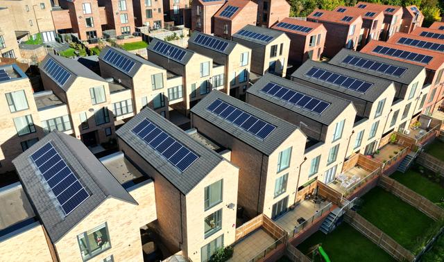 Aerial view of a newly built housing development with solar panels installed on the rooftops